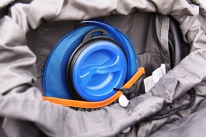 Interior hydration pocket holds a two-liter bladder. Note the drinking tube exits through top center of backpack.