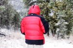 Rear view of Sub Zero SL Parka. Black shoulder and hemline breaks up the red. The apparent loft capability is pure function.