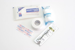 Depending on the size of the wound, you can use one of a variety of bandages, gauze, benzoin tincture and adhesive tape. These are all part of the Mountain Fundamentals Kit from Adventure Medical Kits. 