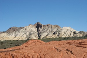 White mountains overlook petrified sand dunes.